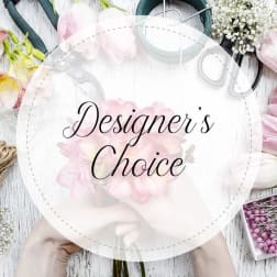 Round floral design board with pink flowers and craft tools