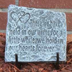 Decorative stone plaque with a heart design and engraved memorial quote