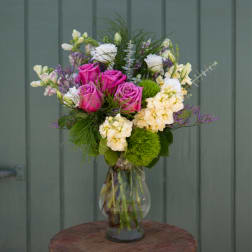 Bouquet of pink and white flowers in a clear glass vase
