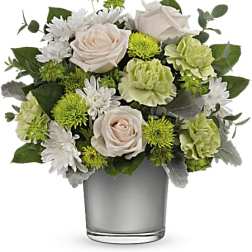 White and green floral arrangement in a clear glass vase