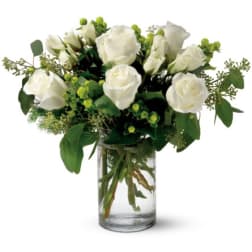 White roses arranged in a clear glass vase