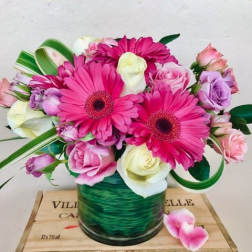 Pink and white mixed bouquet in a green glass vase