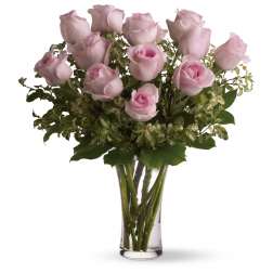 Pink roses arranged in a clear glass vase