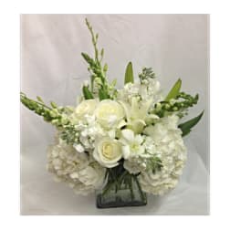 White floral arrangement in a square glass vase