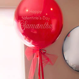 Red Valentine’s Day balloon with a ribbon bow