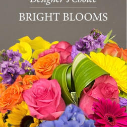 Bright mixed bouquet with roses, calla lilies, sunflowers, and purple blooms
