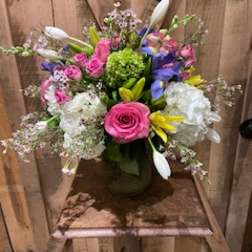 Colorful mixed bouquet in a vase with pink roses and white lilies