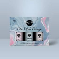 Boxed set of three essential oil blends on a blue and pink marbled background.