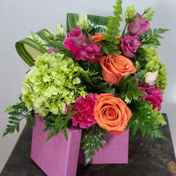 Pink and orange rose arrangement in a pink wooden box