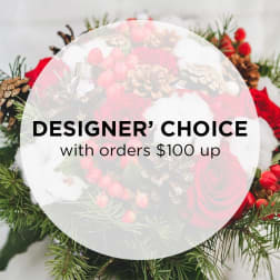 Holiday floral arrangement with red roses and pinecones