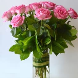 Pink roses arranged in a clear glass vase