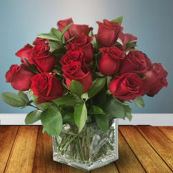 Red roses in a clear glass vase