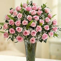 Pink roses arranged in a clear glass vase