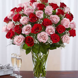 Bouquet of red and pink roses in a clear glass vase