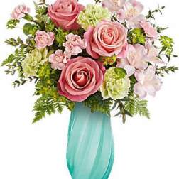 Pink roses and pale flowers in a turquoise vase