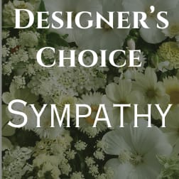White sympathy floral arrangement with large blooms and filler flowers