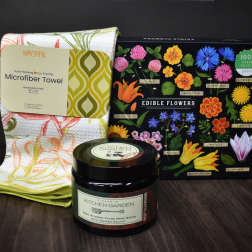 Gift set with a floral kitchen towel, edible flowers puzzle, and hand scrub jar
