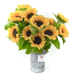 Bouquet of yellow sunflowers in a metal vase