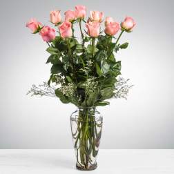 Pink roses arranged in a clear glass vase