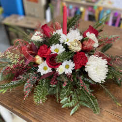 Red and white floral centerpiece with a pink candle and gold ornaments