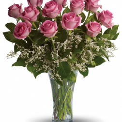 Pink roses arranged in a clear glass vase