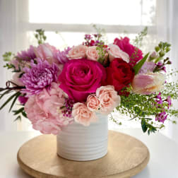 Pink and red roses with hydrangea in a white vase