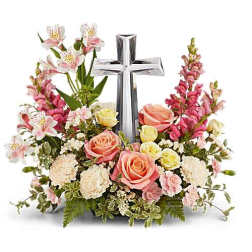 Pink and white floral arrangement with a silver cross centerpiece