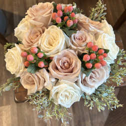 Bouquet of blush and white roses with pink berry accents
