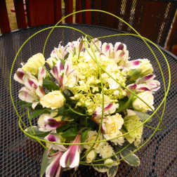 Bouquet of cream and purple flowers with green wire loops