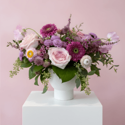 Pink and purple mixed bouquet in a white vase