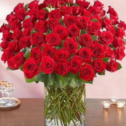 Large bouquet of red roses in a clear glass vase