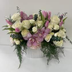 Pink and white floral arrangement in a ribbed white vase