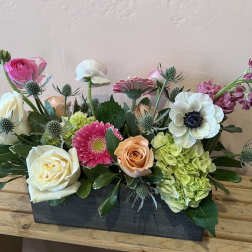 Mixed flower arrangement in a rectangular black container