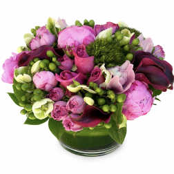 Pink and purple floral arrangement in a glass vase