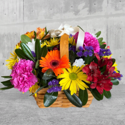 Colorful mixed flower basket with a ribbon handle