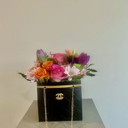 Mixed bouquet in a black box purse with gold chain handles