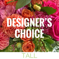 Mixed bouquet of pink, orange, and magenta flowers with green leaves