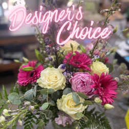 Mixed bouquet with pink gerbera daisies and cream roses in a glass vase