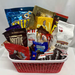 Basket filled with assorted packaged chocolates and cookies