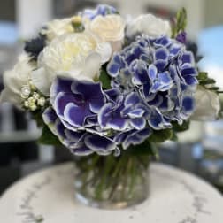 Blue and white bouquet in a clear glass vase