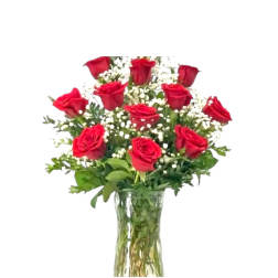 Arrangement of red roses with white filler flowers in a clear glass vase