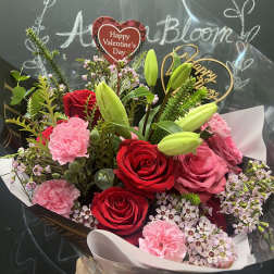 Bouquet of red and pink roses with lilies and carnations