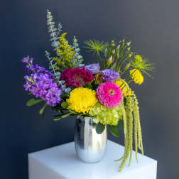 Colorful mixed flower arrangement in a silver vase
