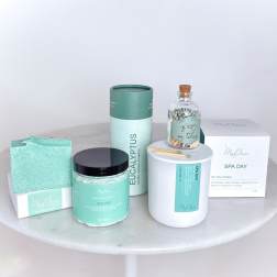 Spa gift set with candles, soap, matches, and bath items in mint packaging