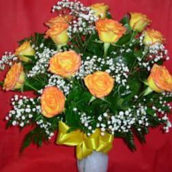 Yellow-orange roses with baby's breath in a white vase