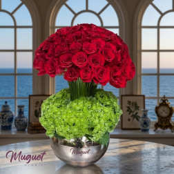 Red rose arrangement with green hydrangeas in a silver bowl