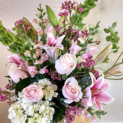 Pink roses, lilies, and white hydrangeas in a mixed bouquet