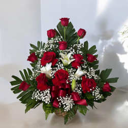 Red roses and white lilies in a basket with baby's breath