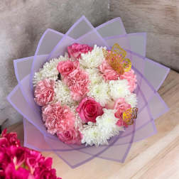 Pink and white bouquet wrapped in lavender paper