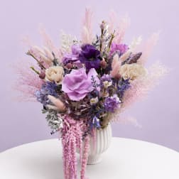 Lavender and pink floral arrangement in a white vase